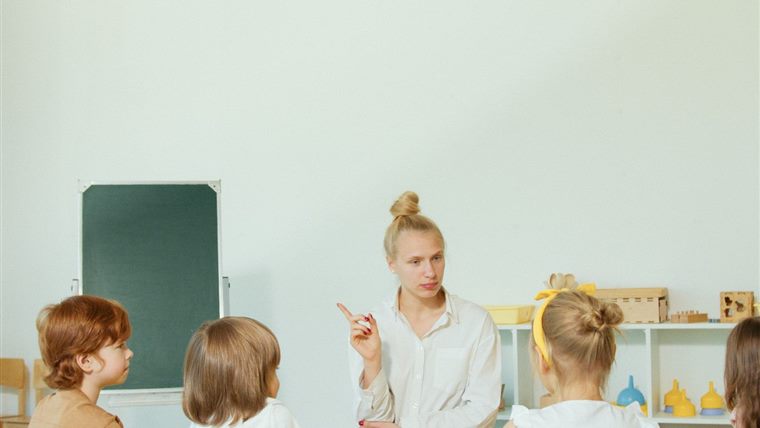 Une classe de maternelle, l'enseignante face à un groupe de jeunes enfants